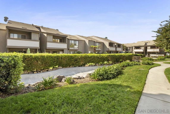 Front view of multiple two-story residential buildings with balconies.