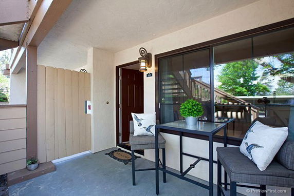 Front view of an apartment entrance with a seating area.