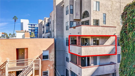 Front view of a multi-story building with balconies.