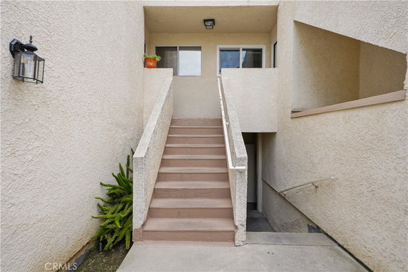 Front view of an entrance with stairs leading to a doorway in a building.