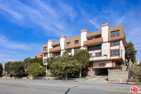 Front view of a multi-story building with a garage entrance.