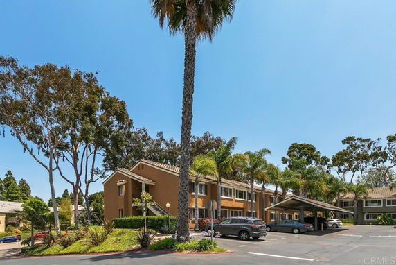 Outdoor view of a residential building with a covered parking area.