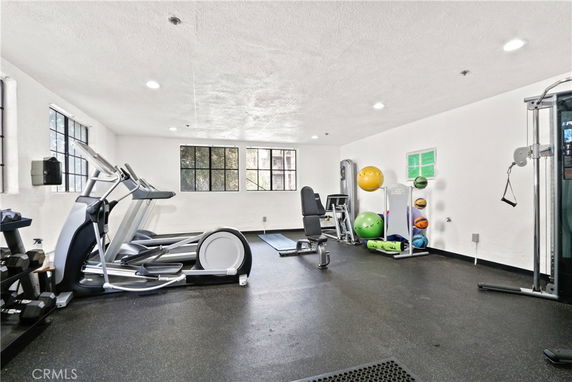 Indoor gym area with exercise equipment and fitness balls.