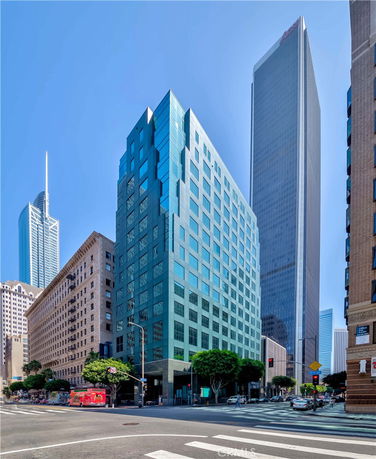 Front view of a multi-story modern office building in an urban area.
