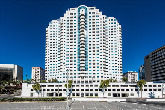 Front view of a high-rise building with multiple floors and a symmetrical facade.