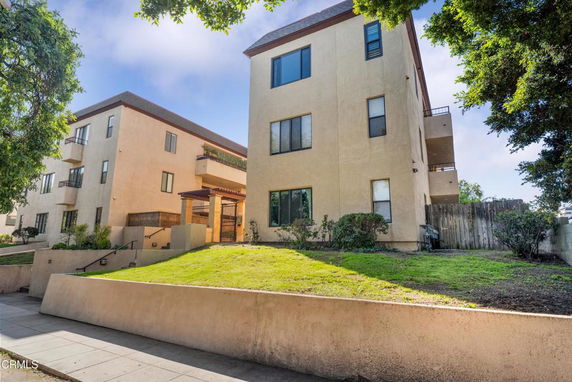 Front view of a multi-story apartment building with balconies.