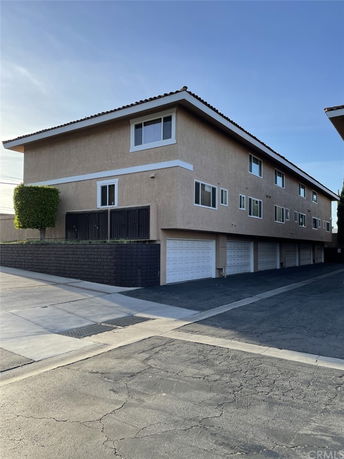 Front view of a multi-story building with multiple garages.