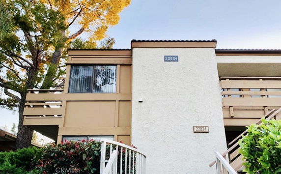 Front view of a two-story house with balconies.