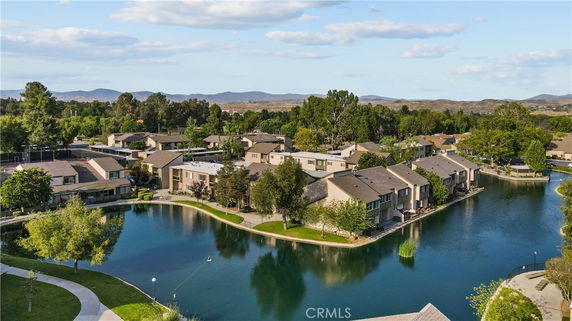 Panoramic view of residential buildings by a small lake.