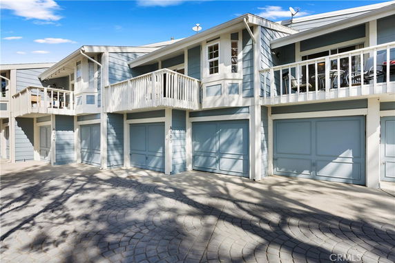 Front view of a multi-story residential building with garages.