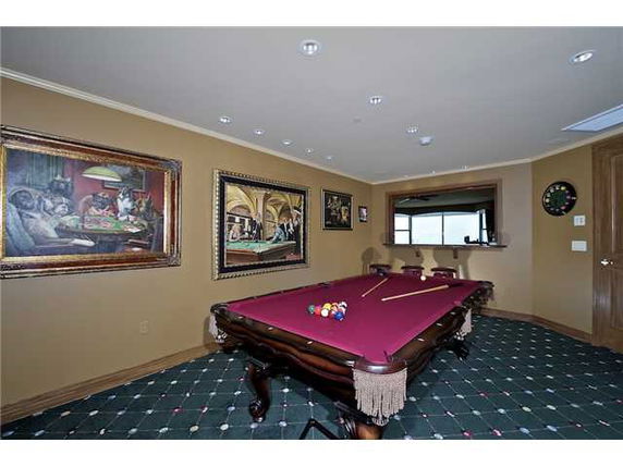Recreation room with a billiards table and wall art.