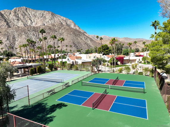Outdoor tennis and pickleball courts with mountain views.