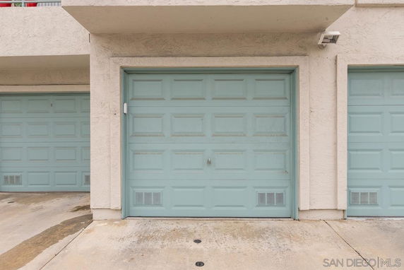 View of a light blue garage door attached to a building.