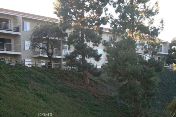 Front view of a multi-story building with balconies.