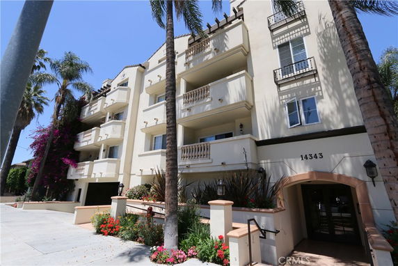 Front view of a multi-story residential building with balconies.
