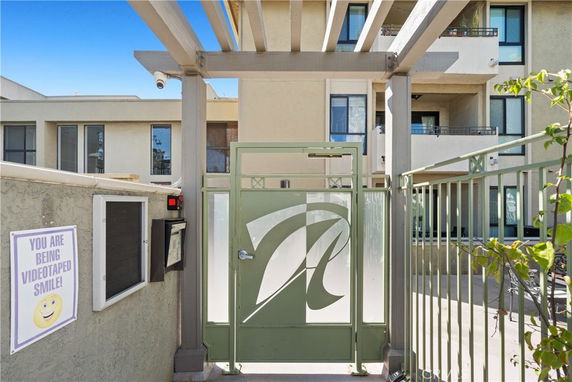 Front view of a multi-story building with a gated entrance.