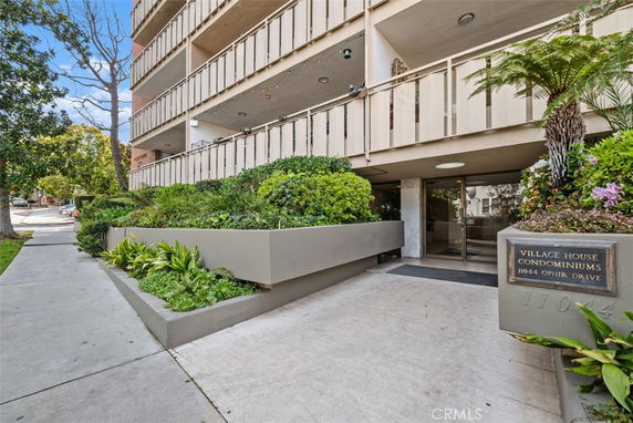 Front view of a multi-story condominium building entrance.