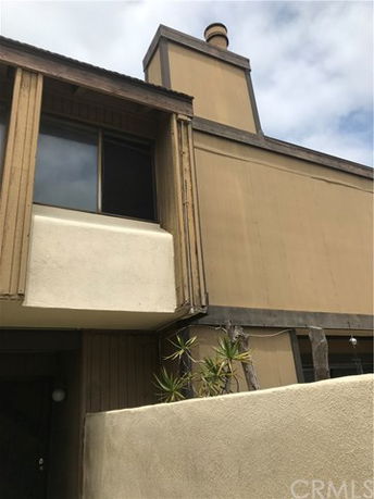 Front view of a multi-story house with chimney.