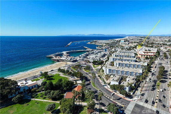 Wide angle view of coastal area with ocean and buildings.