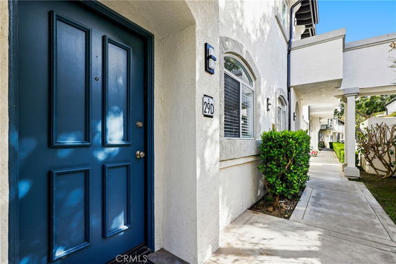 Front view of a multi-story building entrance with a blue door.