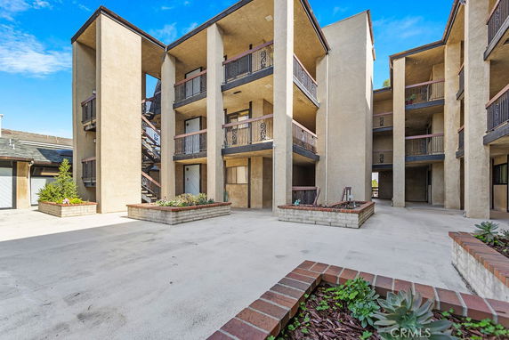 Front view of a multi-story apartment complex with balconies.