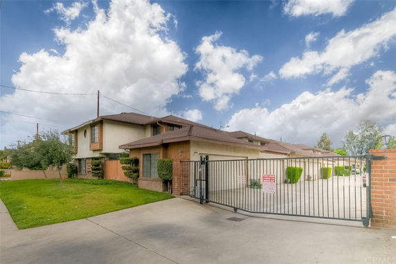 Front view of a two-story house with a gated driveway.