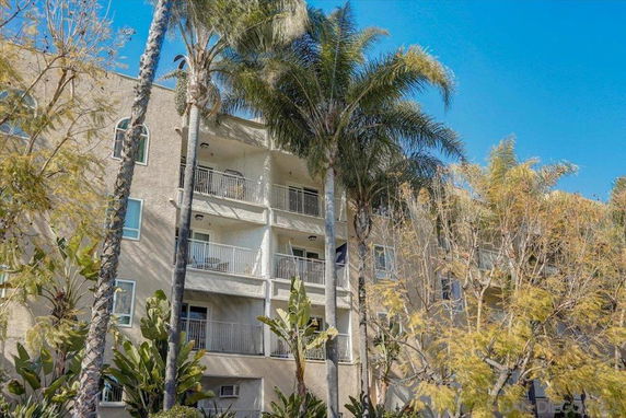 Front view of a multi-story apartment building with balconies.