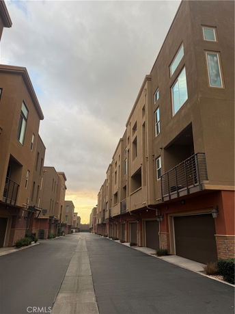 Front view of multi-story residential buildings with garages on the ground level.