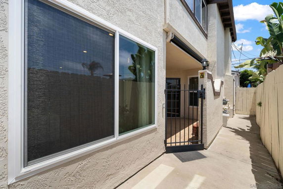 Front view of a two-story house with a gated entrance.
