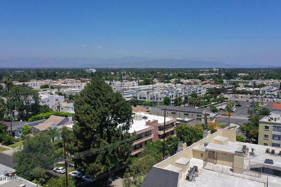 Panoramic view of a cityscape with residential and commercial buildings.