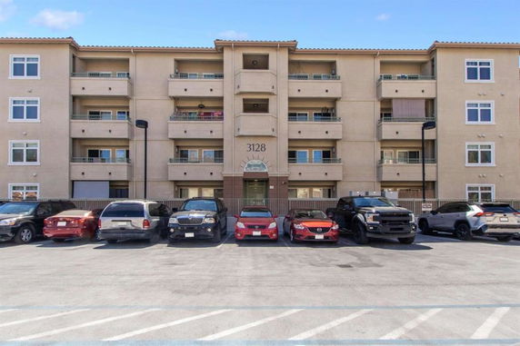 Front view of a four-story residential building with balconies.