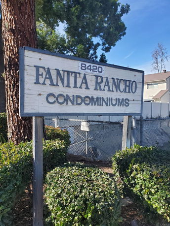Front view of a building sign for Fanita Rancho Condominiums.
