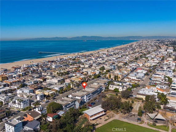 Panoramic view of a seaside neighborhood with a beach and ocean in the background.