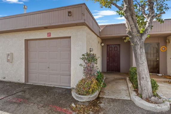 Front view of a house with an attached garage and two entry doors.