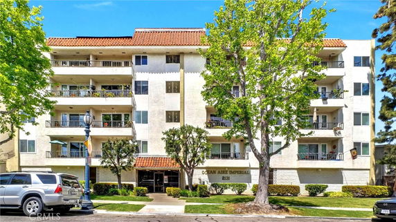 Front view of a multi-story residential building with balconies.