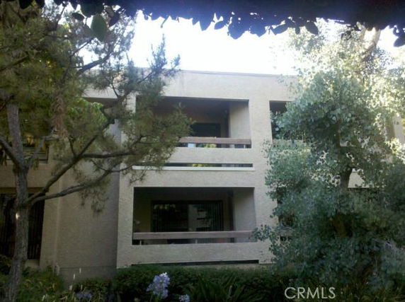 Front view of a two-story building with balconies.