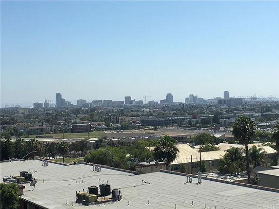 Wide view of cityscape with buildings and rooftops visible.