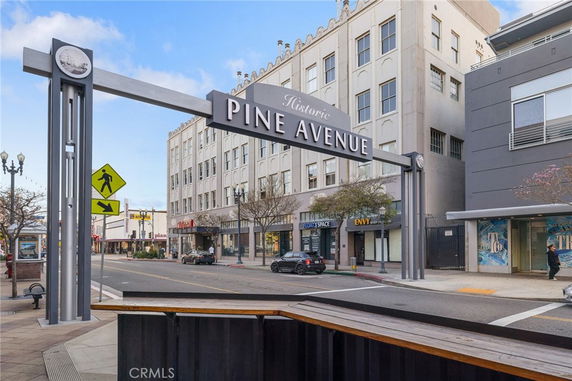 Street view showing the front of a multi-story historic building on Pine Avenue.
