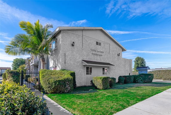 Front view of a two-story building labeled Vista Garden Townhomes.