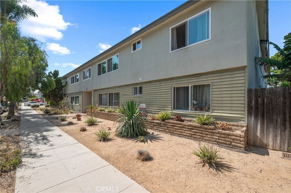 Front view of a two-story residential building with a flat roof.