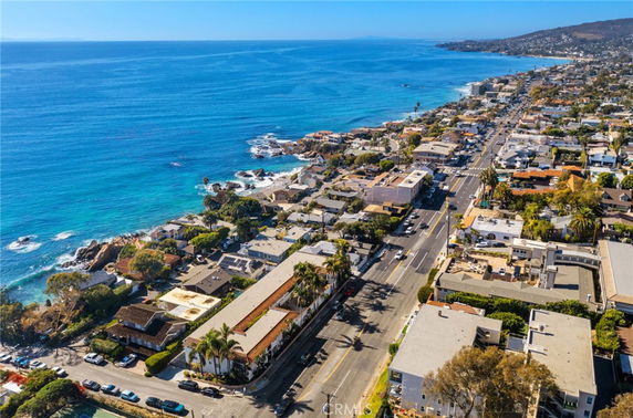 Panoramic view of a coastal area with buildings and roads along the shoreline.