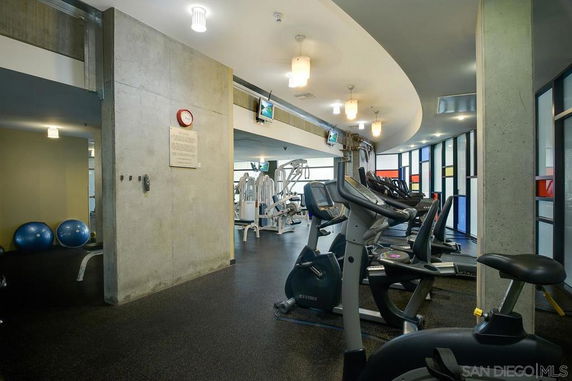 Interior view of a gym with exercise equipment and exercise bikes.