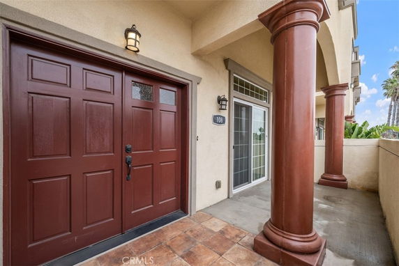 Front view of a house with large columns and a double door entrance.
