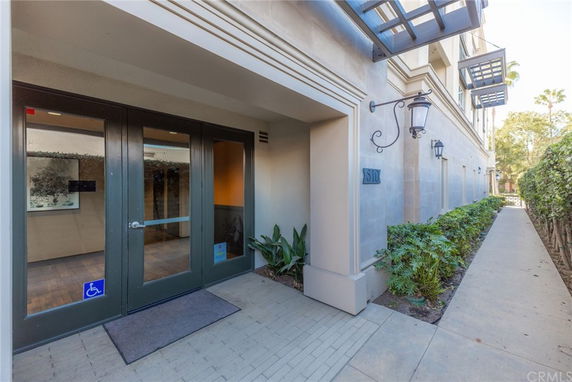 Front view of a building entrance with glass doors and outdoor lighting.