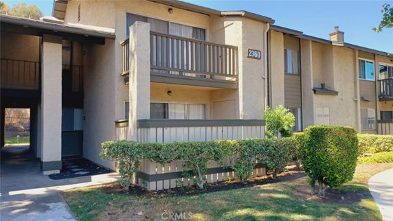 Front view of a two-story apartment building with balconies.