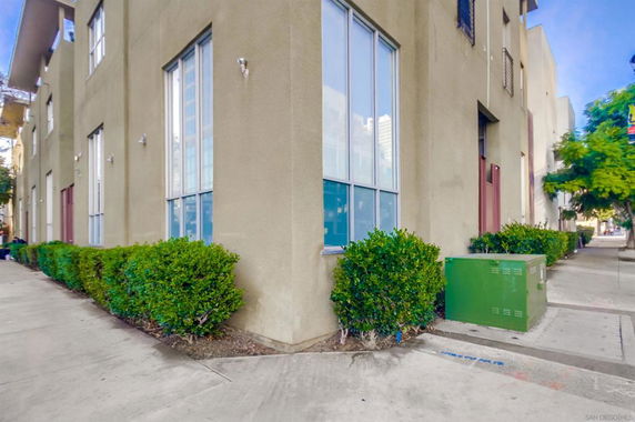 Corner view of a multi-story building with large windows.
