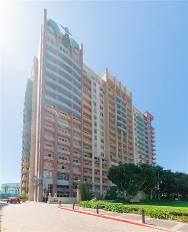 Front view of a multi-story residential building with balconies.