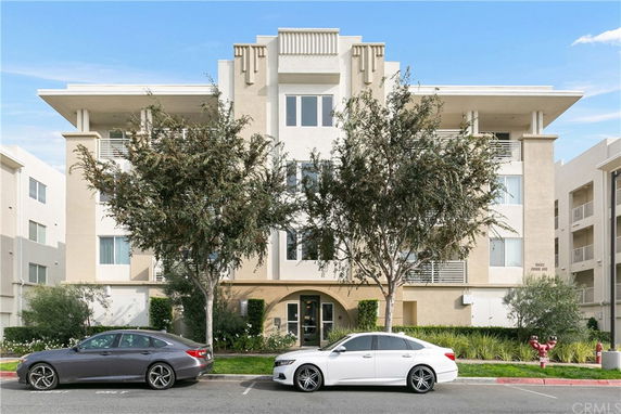 Front view of a multi-story apartment building with a modern facade.