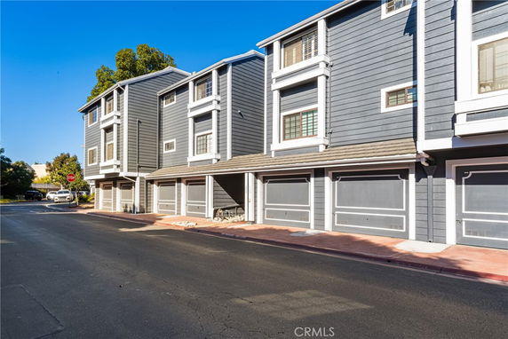 Front view of a multi-story residential building with garages.