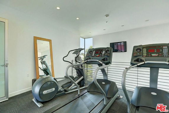 Indoor gym area with treadmills and exercise equipment.